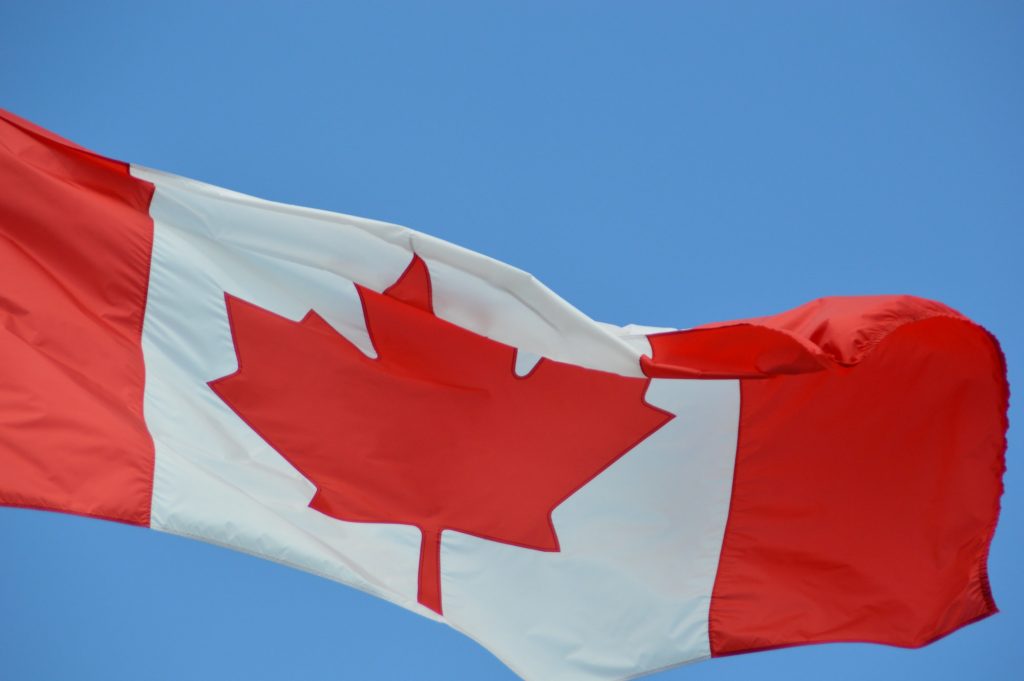 Canada flag against blue sky